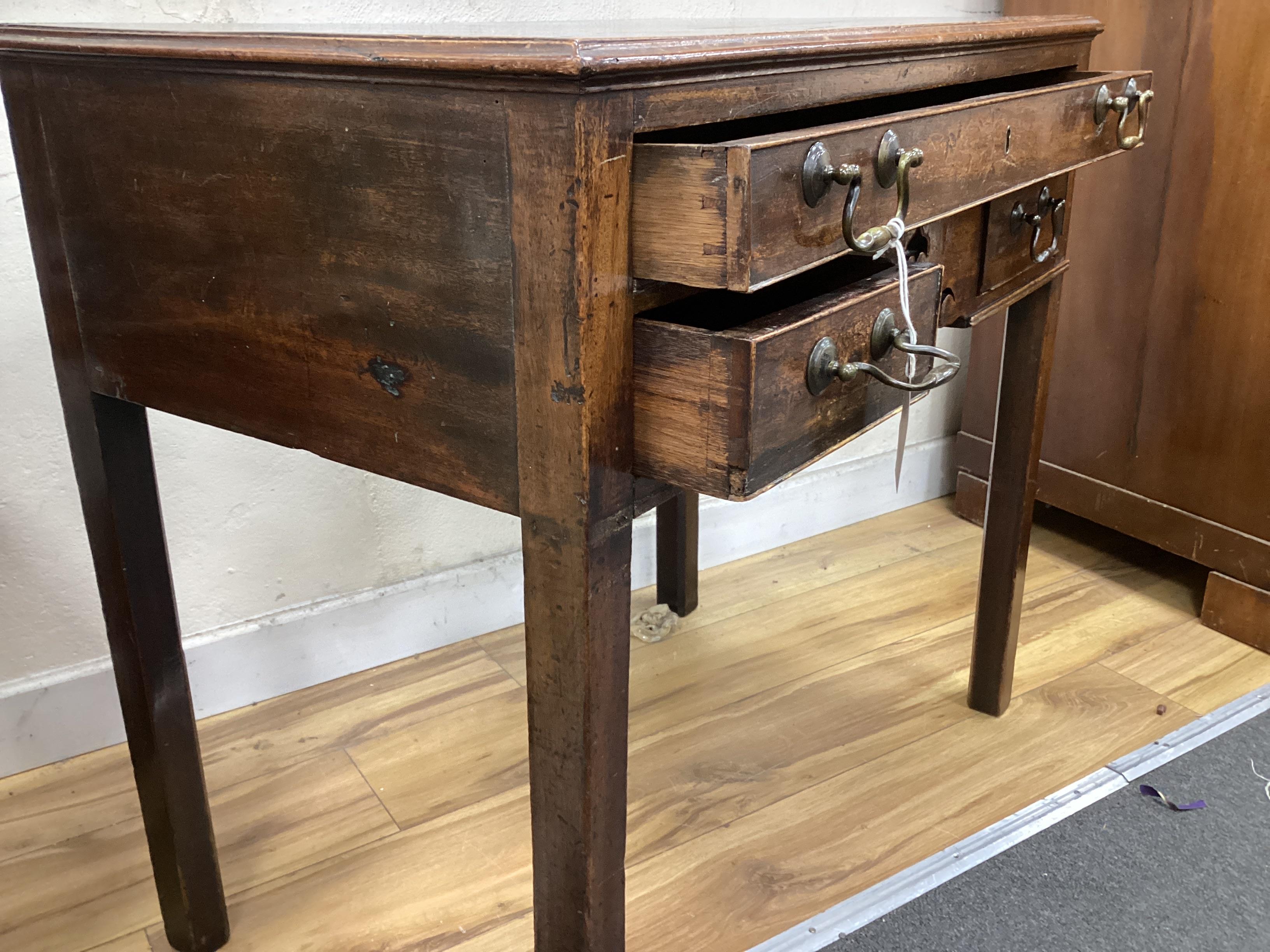 A George III mahogany three drawer side table width 75cm, depth 46cm, height 70cm